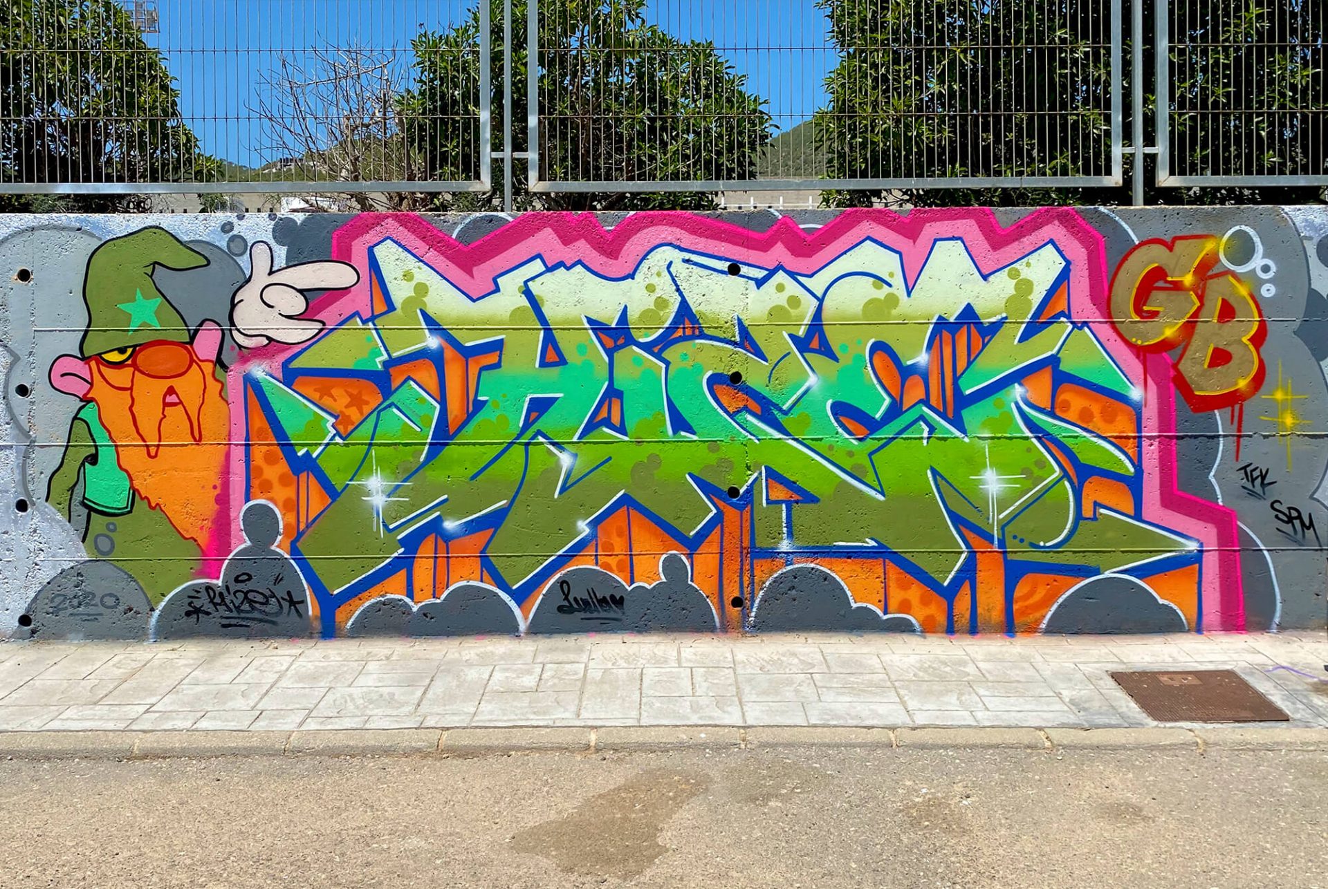 Hize Ibiza graffiti mural with green and orange wildstyle letters